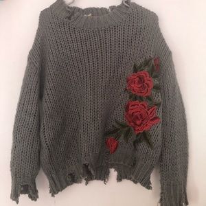 Ripped sweater with roses